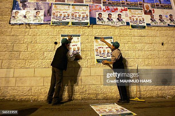 Palestinian supporters of Hamas movement put election posters in Gaza city streets early 03 January 2006.The offical start of campaigning for the...