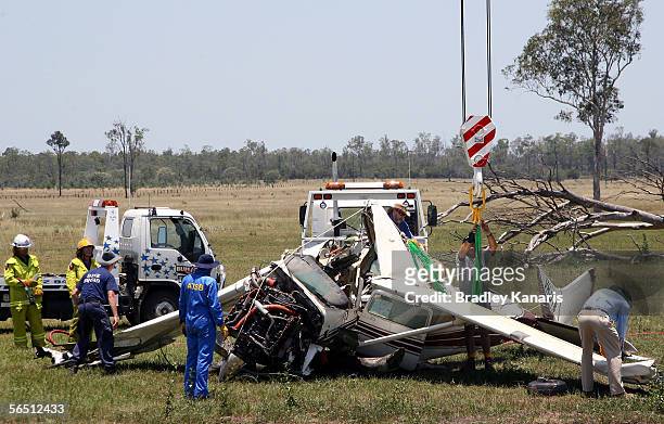 Investigators looks at a crashed Cessna 206 January 3, 2006 in Ipswich, Australia. The aircraft crashed into a catchment dam on January 2, 2006 after...