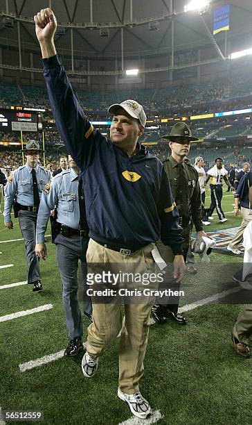 Head coach Rich Rodriguez of the West Virginia Mountaineers walks off the field after defeating the Georgia Bulldogs 38-35 in the Nokia Sugar Bowl at...