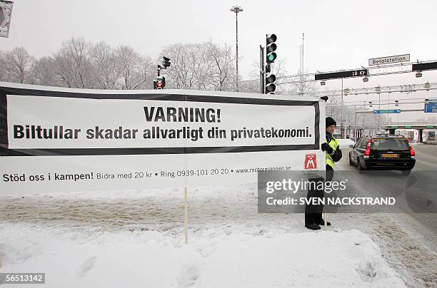 "Warning - Road tools pose a serious hazard to your personal finances" is written on a banner hoisted by a protesting Swedish drivers organization at...