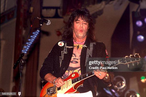 American musician Ace Frehley plays guitar as he performs on stage at the Aragon Ballroom, Chicago, Illinois, September 4, 1987.