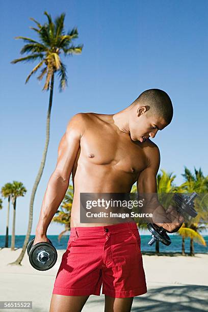 man working out on the beach - red shorts stock pictures, royalty-free photos & images