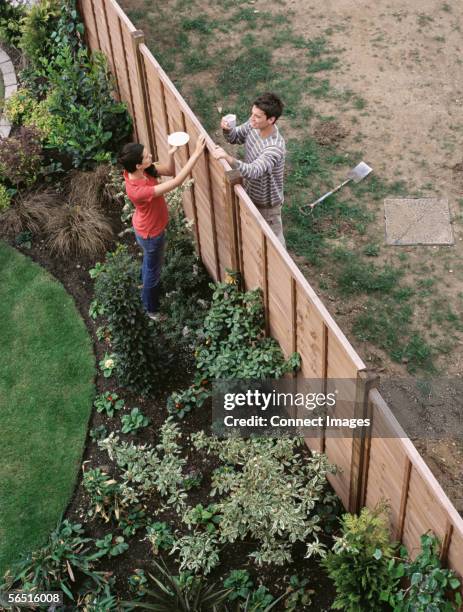 neighbours having coffee over the fence - nachbar stock-fotos und bilder