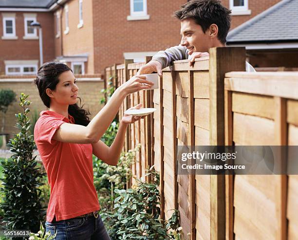 woman giving coffee to neighbour - neighbors fotografías e imágenes de stock