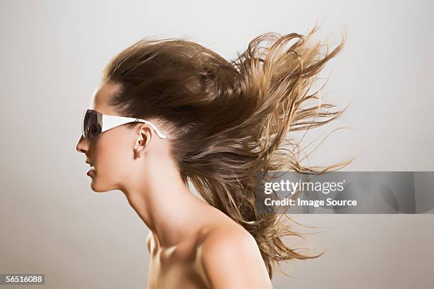 woman in sunglasses with windswept hair - windswept stock pictures, royalty-free photos & images