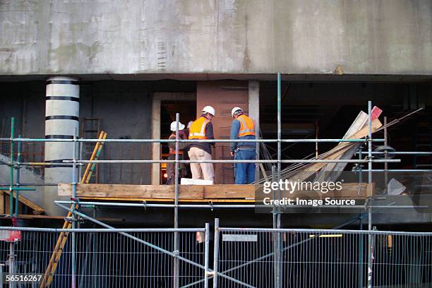 men up on construction site - three storey stock pictures, royalty-free photos & images