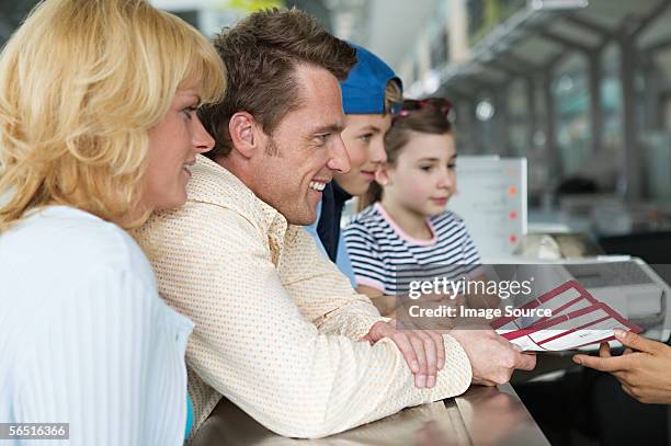 family at airport check in - four people stock pictures, royalty-free photos & images