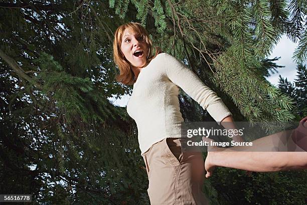 man reaching to touch woman's bottom - smacking-bottom stock pictures, royalty-free photos & images