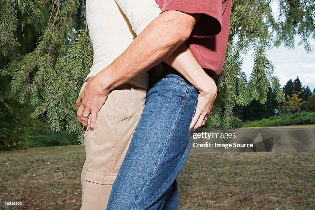 Couple gripping each other's buttocks