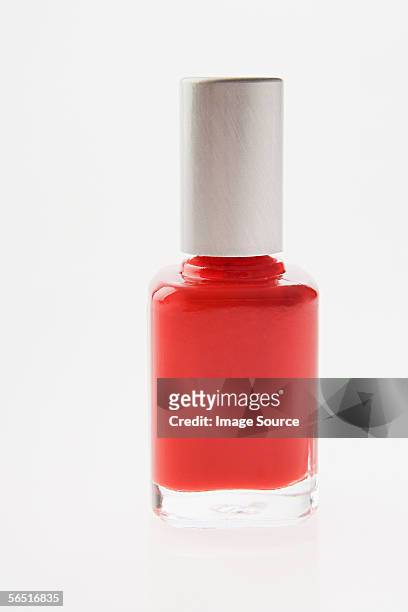 bottle of red nail varnish - red nail polish stockfoto's en -beelden