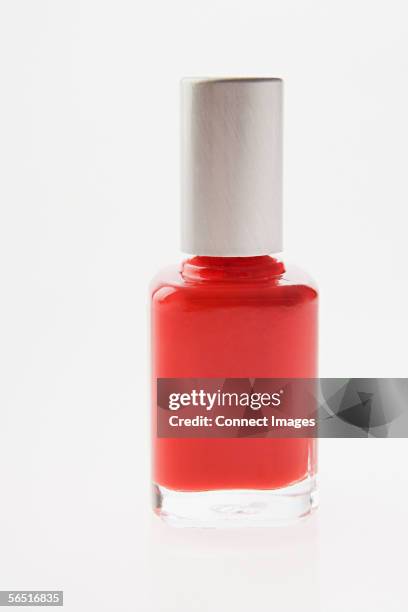 bottle of red nail varnish - nail polish stock pictures, royalty-free photos & images