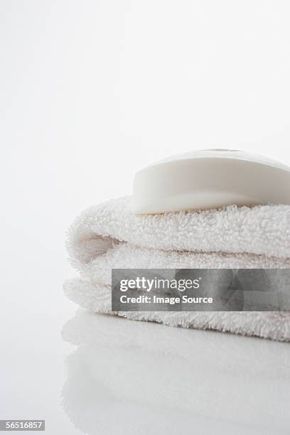 soap on a white towel - folded towel stock-fotos und bilder