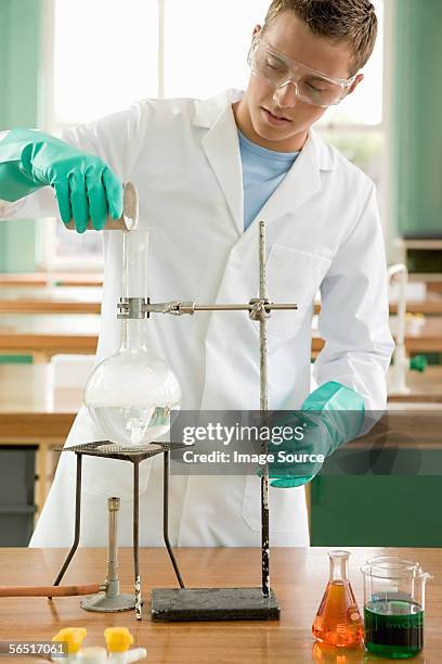 boy doing a science experiment - bunsen burner stock pictures, royalty-free photos & images