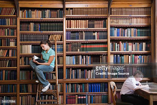 school students in the library - teenagers reading books stock pictures, royalty-free photos & images