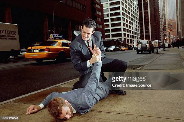 businessmen fighting in street - streetfight stock-fotos und bilder