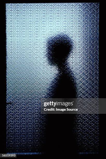 silhouetted person through window - unrecognizable person stock pictures, royalty-free photos & images