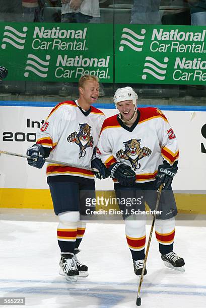 Right wing Valeri Bure of the Florida Panthers laughs with defenseman Robert Svehla before the NHL game against the Ottawa Senators at National Car...