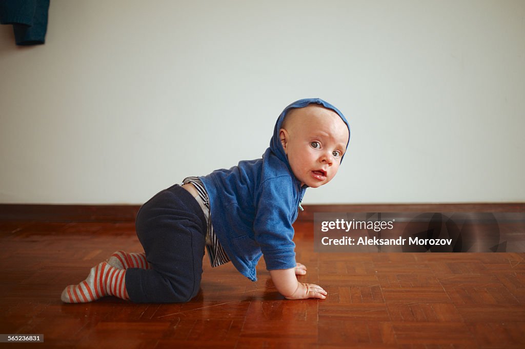 Boy crawling around the room