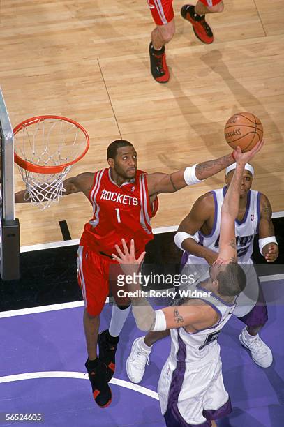 Tracy McGrady of the Houston Rockets and Brad Miller of the Sacramento Kings attempt to rebound during the game at the Arco Arena on December 8, 2008...