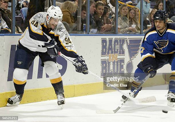 Yanic Perreault of the Nashville Predators passes the puck as Bryce Salvador of the St. Louis Blues defends on January 4, 2006 at the Savvis Center...