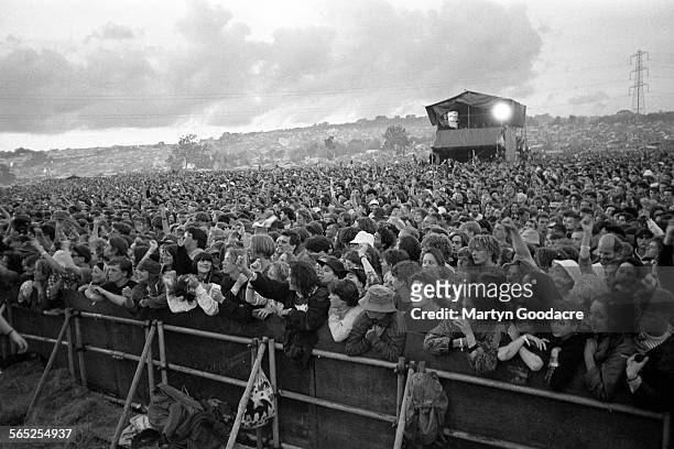 General view of the front rows of the crowd in front of the Pyramid Stage, Glastonbury Festival, United Kingdom, 1990.