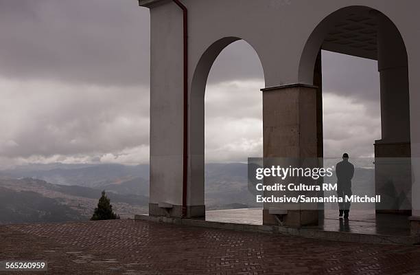 silhouette of male tourist looking out from monserrate mountain, bogota, colombia, south america - monserrate bogota stock pictures, royalty-free photos & images