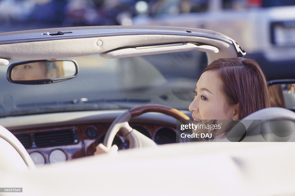 Young woman driving a car