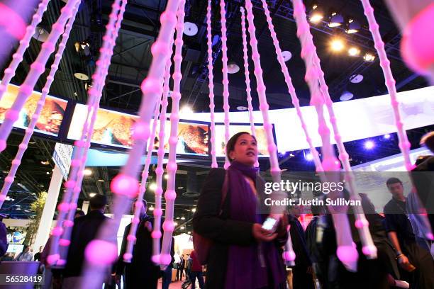 An attendee walks through a display of lights at the Intel booth on the opening day of the 2006 Consumer Electronics Show January 5, 2006 in Las...