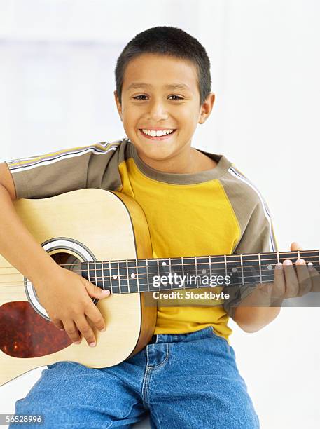 portrait of a boy playing a guitar - acoustic guitar white background stock pictures, royalty-free photos & images