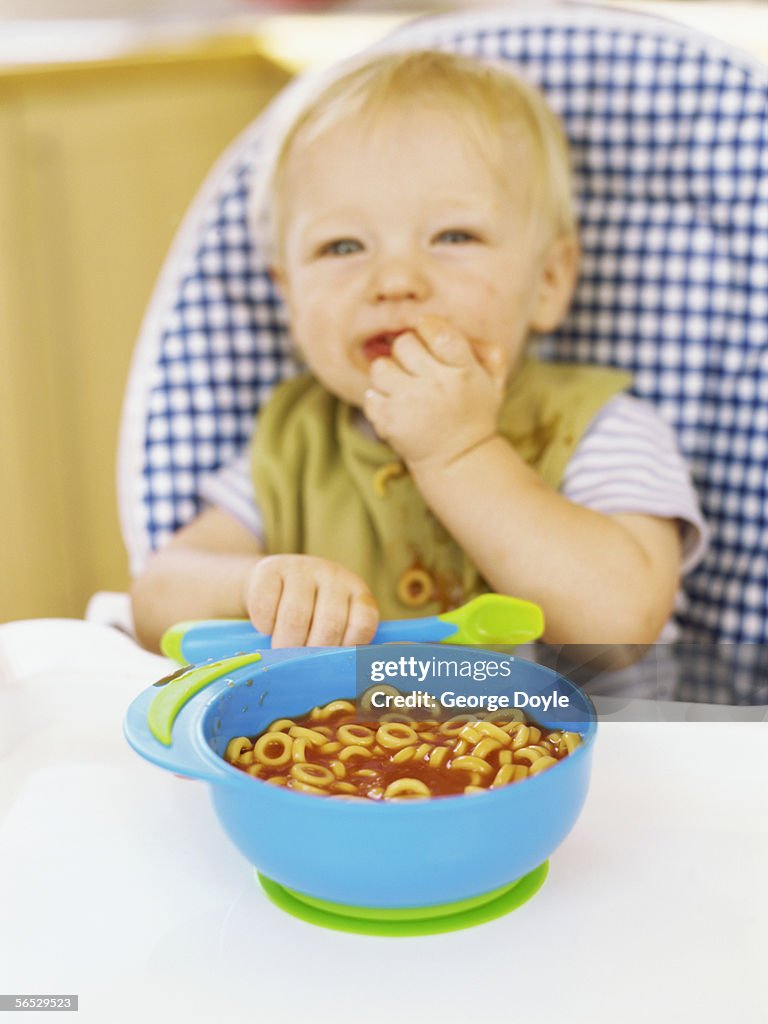 High angle view of a baby boy eating cereal