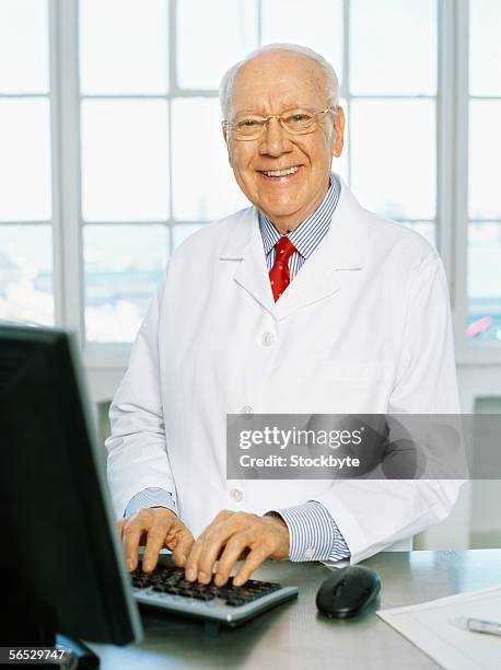 portrait of a male scientist using a computer - hairless mouse stock pictures, royalty-free photos & images