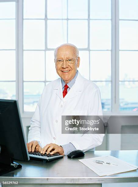 portrait of a male scientist using a computer - hairless mouse stock pictures, royalty-free photos & images