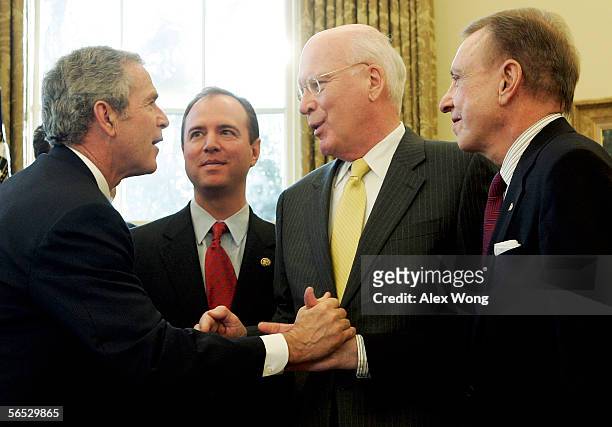 President George W. Bush shakes hands with Sen. Arlen Specter as Sen. Patrick Leahy and Rep. Adam Schiff look on after a signing ceremony in the Oval...
