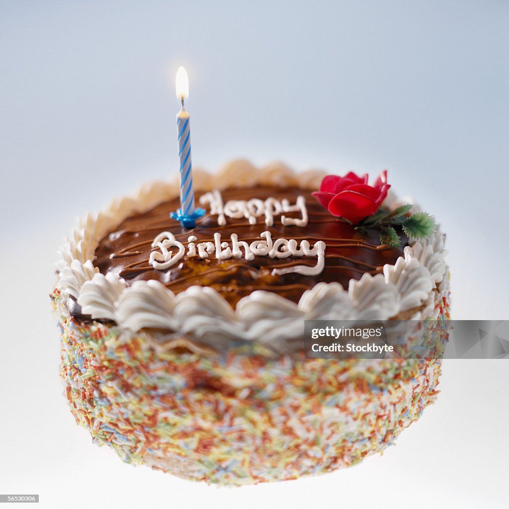 Lit candle on a birthday cake