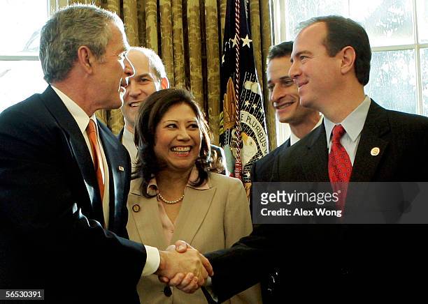 President George W. Bush shakes hands with Rep. Adam Schiff as Rep. Rick Larsen , Rep. Hilda Solis and Rep. Anthony Weiner look on during a signing...