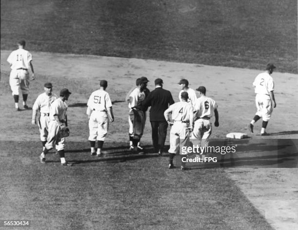 Members of the Chicago Cubs baseball team protest umpire George Moriarty and his decisiion to call Phil Cavarretta out after an attempted steal...