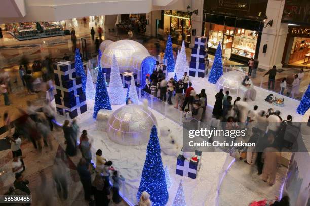 Shoppers swirl around Christmas decorations in the interior of the newly constucted Emirates Mall December 15, 2005 in Dubai, United Arab Emirates....