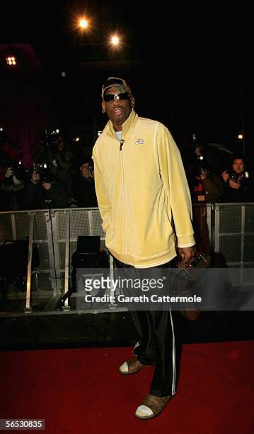 Former basketball player Dennis Rodman poses for photographers as he enters the new Celebrity Big Brother house for the new series of the reality TV...