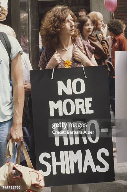 Woman carries a placard reading 'No More Hiroshima's' at an anti-nuclear demonstration, New York City, USA, 12th June 1982.