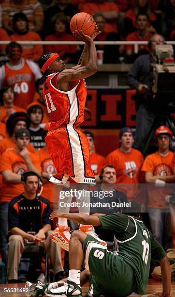 Dee Brown of the Illinois Fighting Illini puts up a shot over Maurice Ager of the Michigan State Spartans on his way to a career high 34 points on...