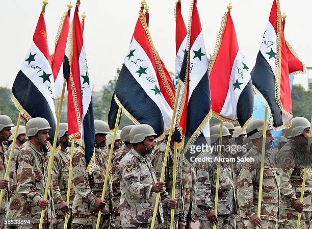 Iraqi soldiers carry Iraqi flags at the Tomb of the Unknown Soldier, during an Army Day parade on January 6 in Baghdad, Iraq. The Iraqi Army was...