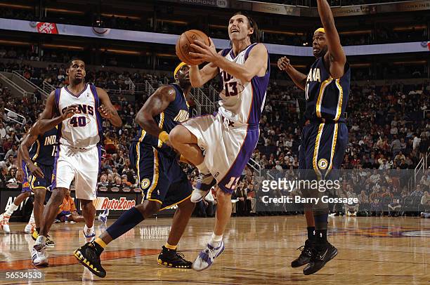 Steve Nash of the Phoenix Suns drives to the basket past Jermaine O'Neal and Jamaal Tinsley of the Indiana Pacers on November 30, 2005 at America...