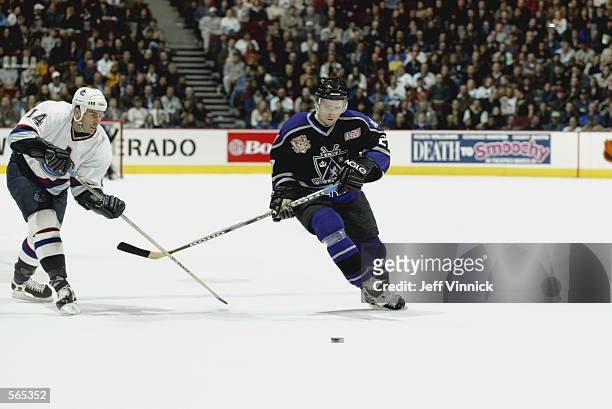 Jaroslav Bednar of the Los Angeles Kings moves for the puck against Scott Lachance of the Vancouver Canucks at the General Motors Place in Vancouver,...
