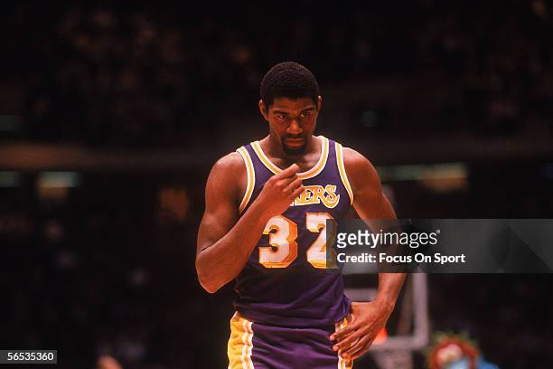 Center Magic Johnson of the Los Angeles Lakers walks on the court circa the 1980's during a game against the Philadelphia Sixers.