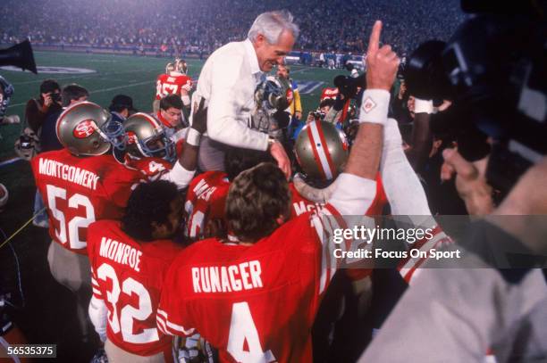 Coach Bill Walsh is held up by his San Francisco 49ers players after defeating the Cincinnati Bengals 26-21 for Super Bowl XVI at the Pontiac...