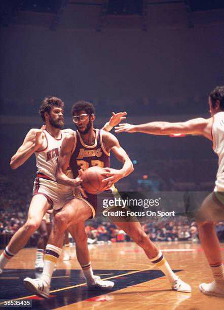 Kareem Abdul Jabbar of the Los Angeles Lakers dribbles near the net against the New Jersey Nets circa the 1970's during a game.