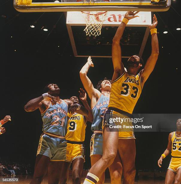 Kareem Abdul-Jabbar of the Los Angeles Lakers jumps and grabs the rebound from the San Diego Clippers circa the 1970's during a game.