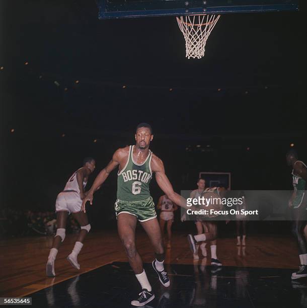 Bill Russell of the Boston Celtics takes the ball after a New York Knicks score circa the 1960's during a game.