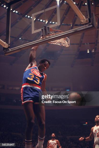 David Thompson of the Denver Nuggets dunks the ball against the New York Knicks circa the 1970's during a game.