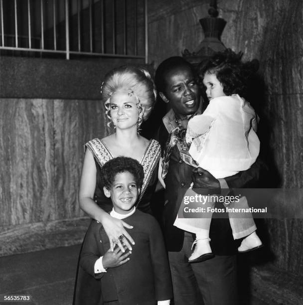 American soul singer Lou Rawls holds his daughter Louanna as his wife Lana Jean and son Lou Jr. Stand with him at the opening of his stint at the...